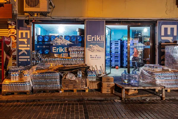 A brightly lit street kiosk at night.