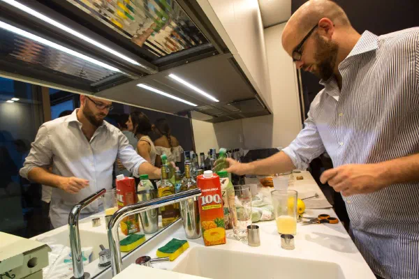 Drinks being prepared at a kitchen counter during a private event.