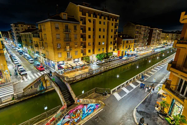 A canal and surrounding streets illuminated at night.